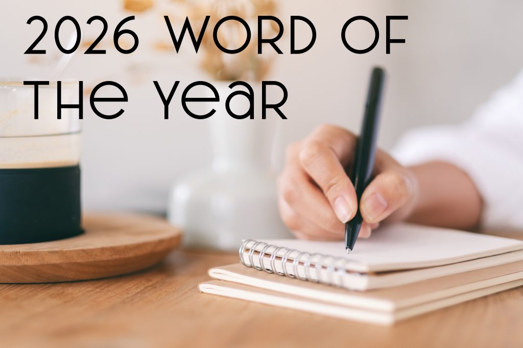 2026 Word of the Year. Woman's hand writing on a notepad.